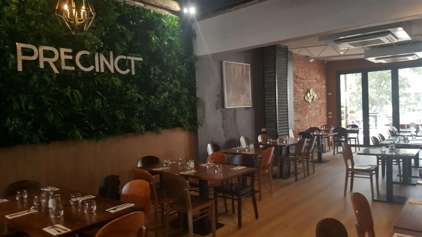 Dining room with green wall and exposed brick